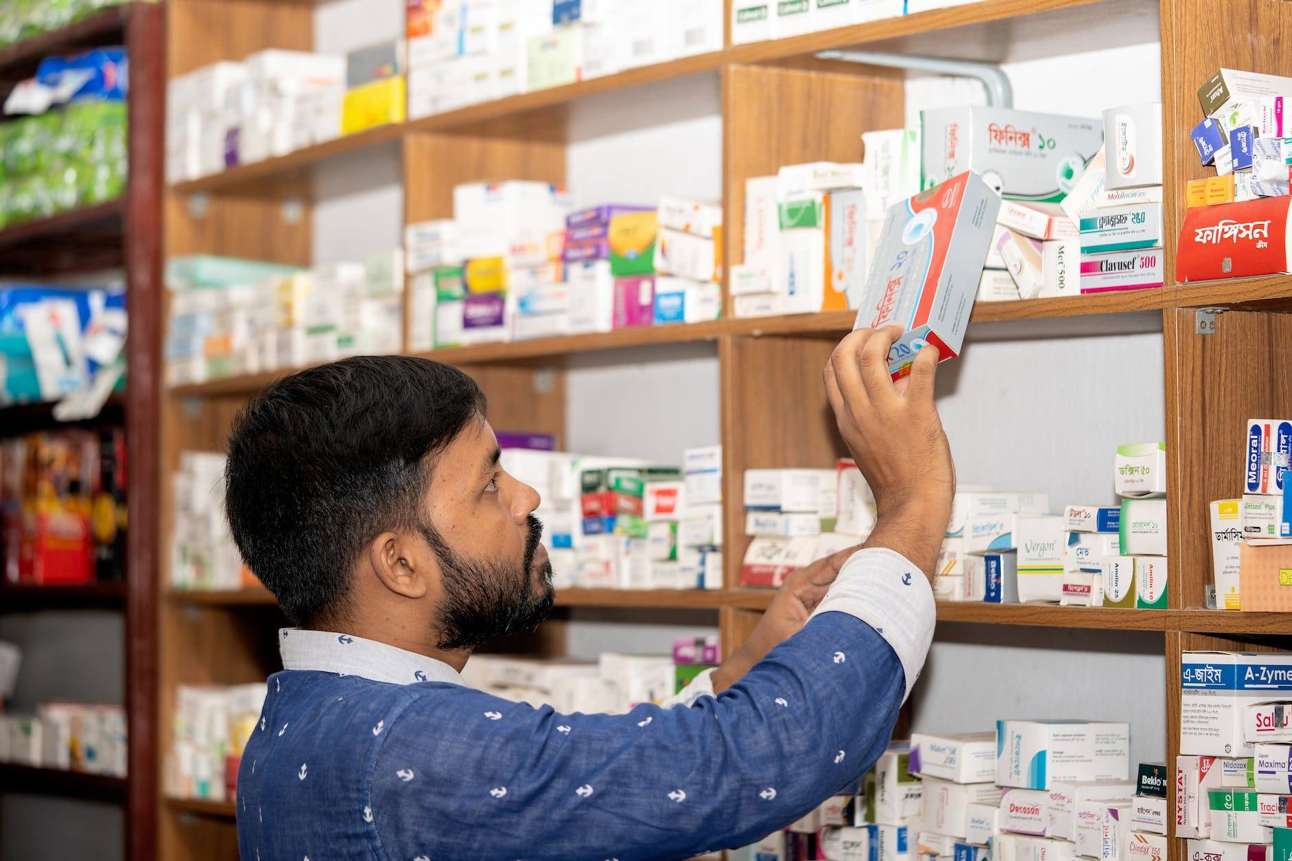 professional pharmacist in modern drugstore space for text